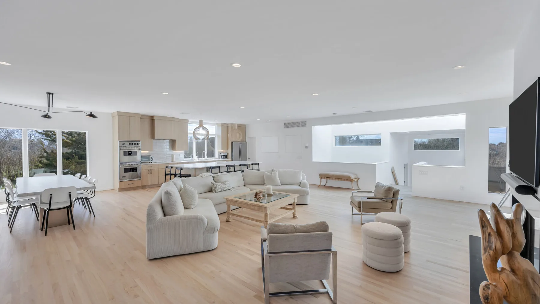 An open-plan living and dining room with seating around a low coffee table.