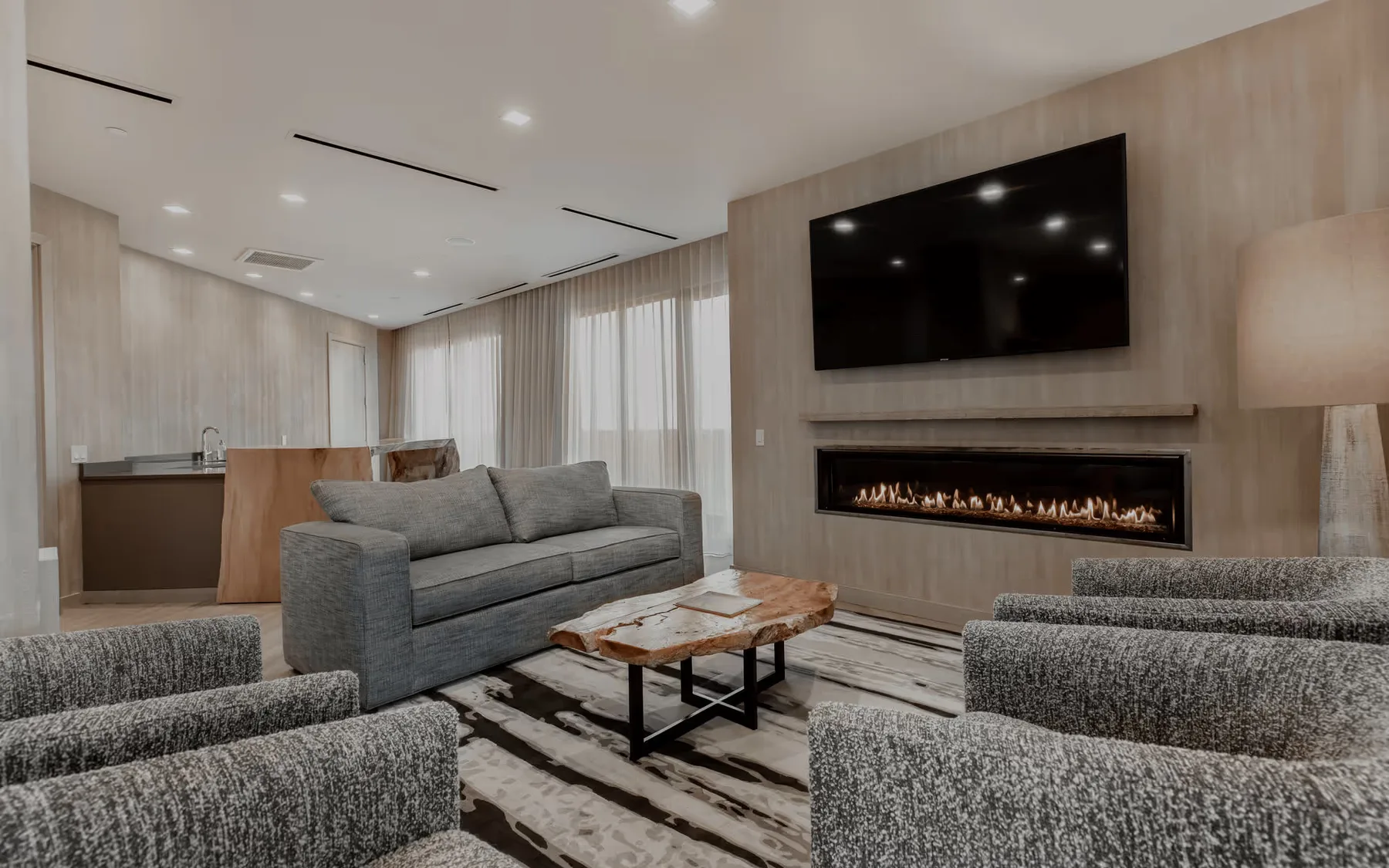 Terrace Suite living room with couches, television, and electric fireplace