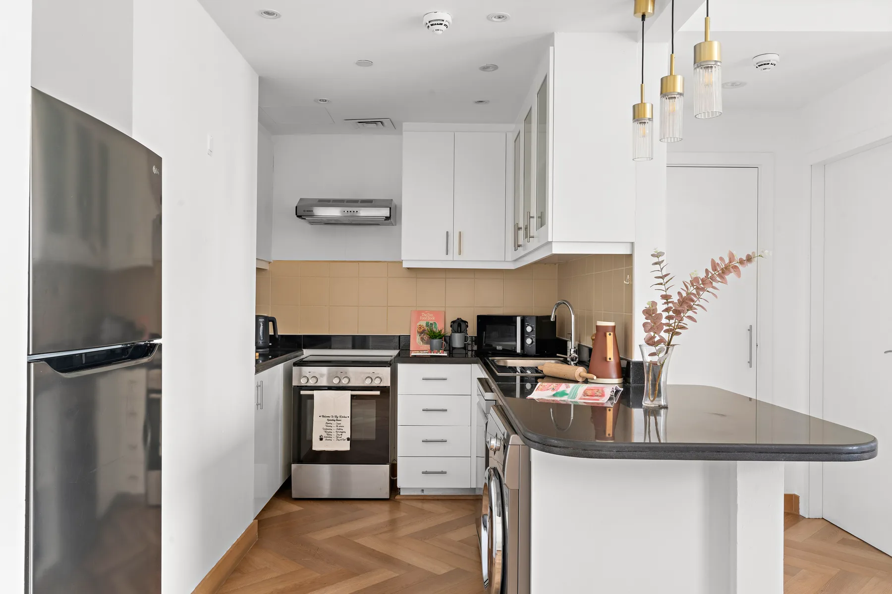 A bright modern kitchen with white cabinetry and a central island.