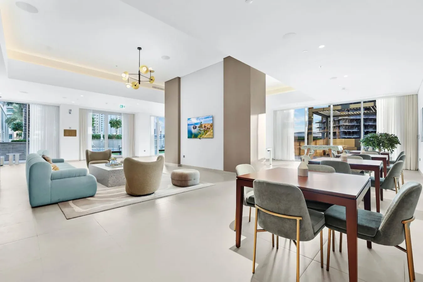 A bright open-plan lounge and dining area with tables and seating.