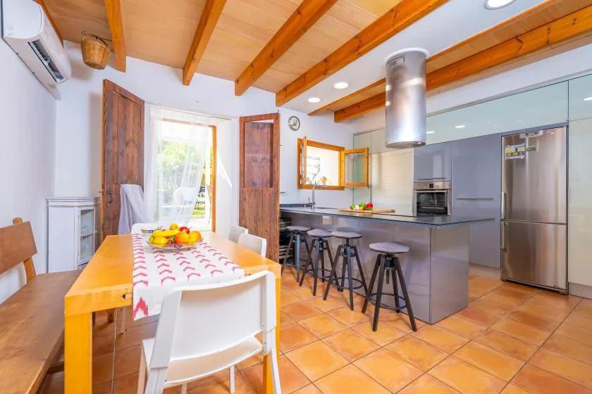 Comedor y cocina de planta abierta con una mesa y una isla central.