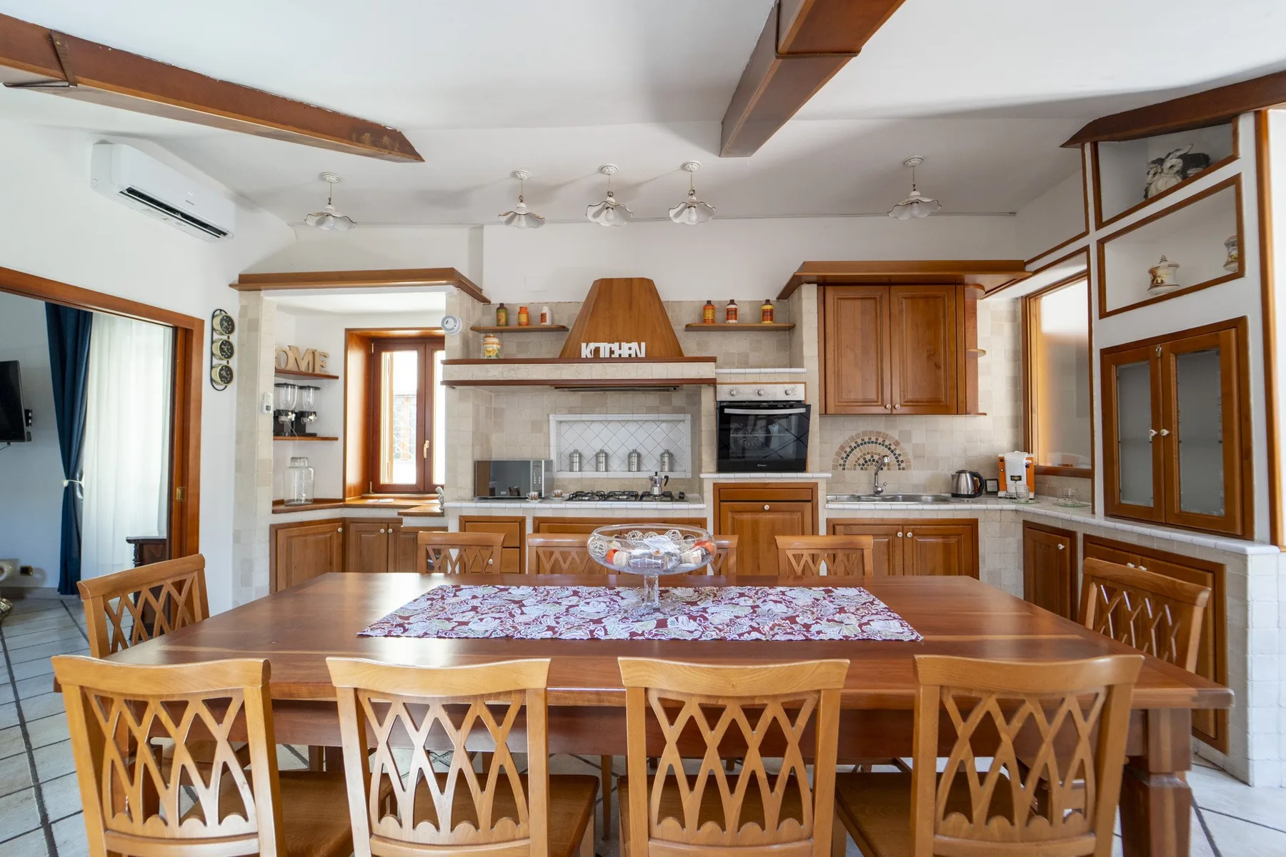 A spacious kitchen and dining area with wooden cabinetry and a large dining table.
