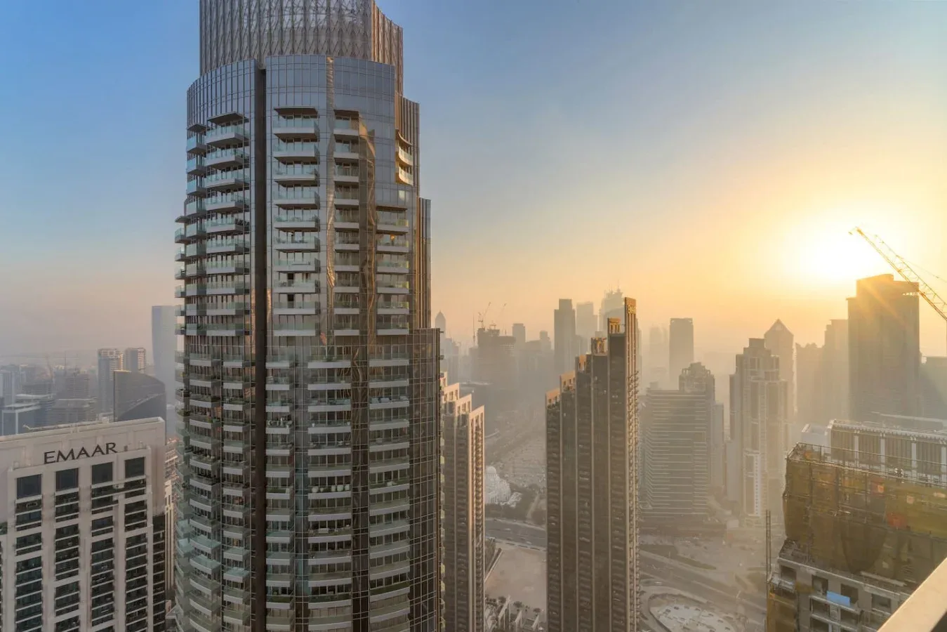 City skyline at sunset, with tall high-rise buildings in the foreground.