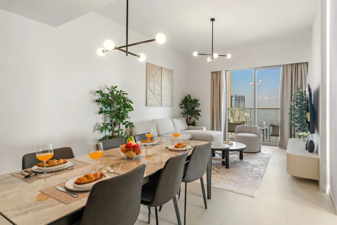 A bright living and dining area with a table, seating, and sliding glass doors.