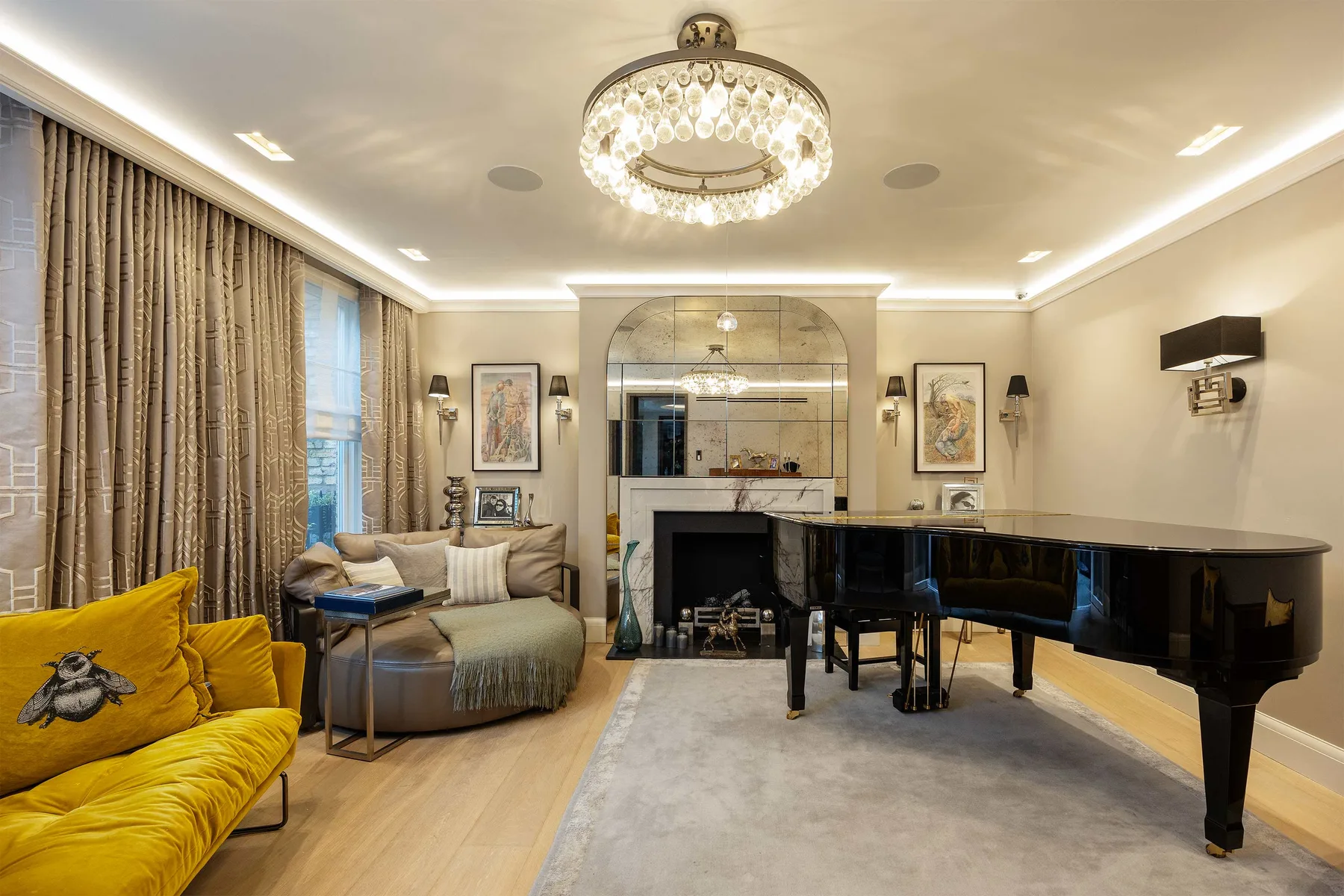 An elegant living room with a grand piano and seating around a fireplace.
