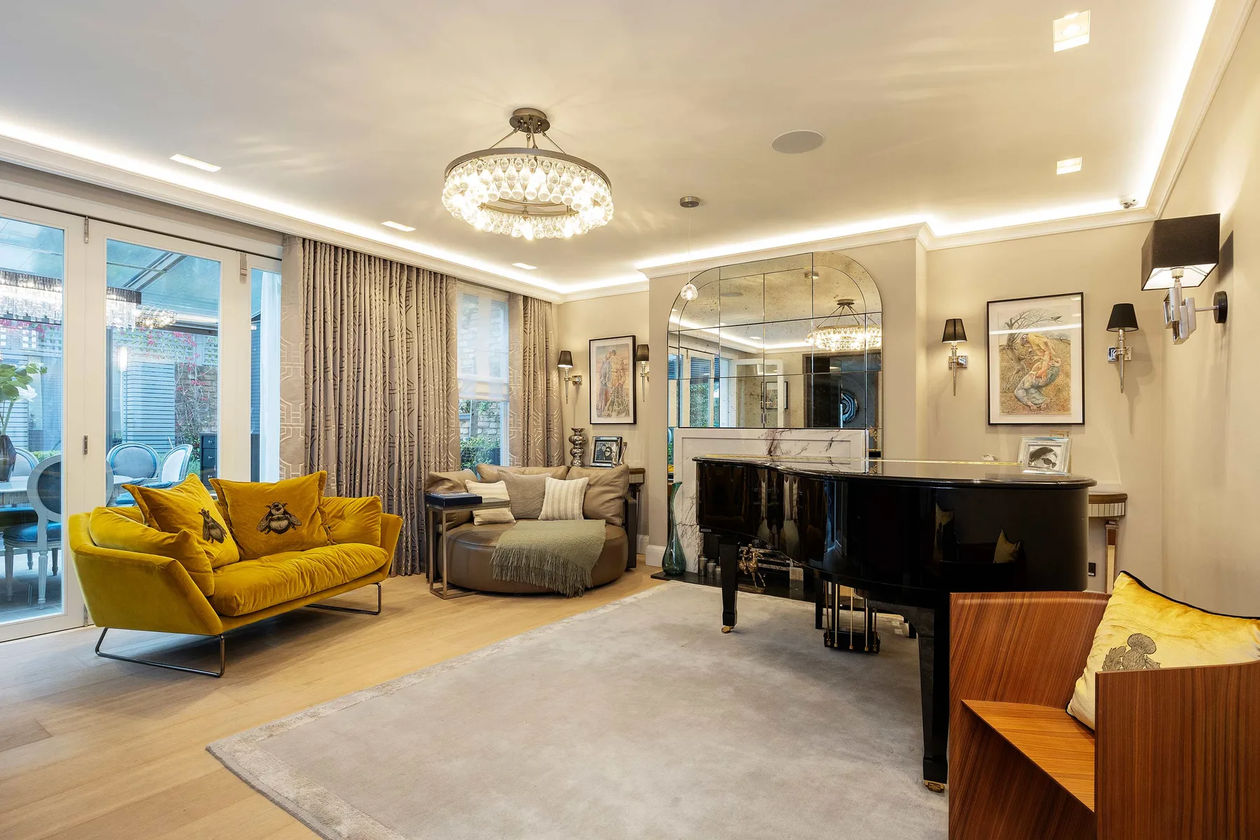 A living room with a grand piano, yellow seating, and large windows.