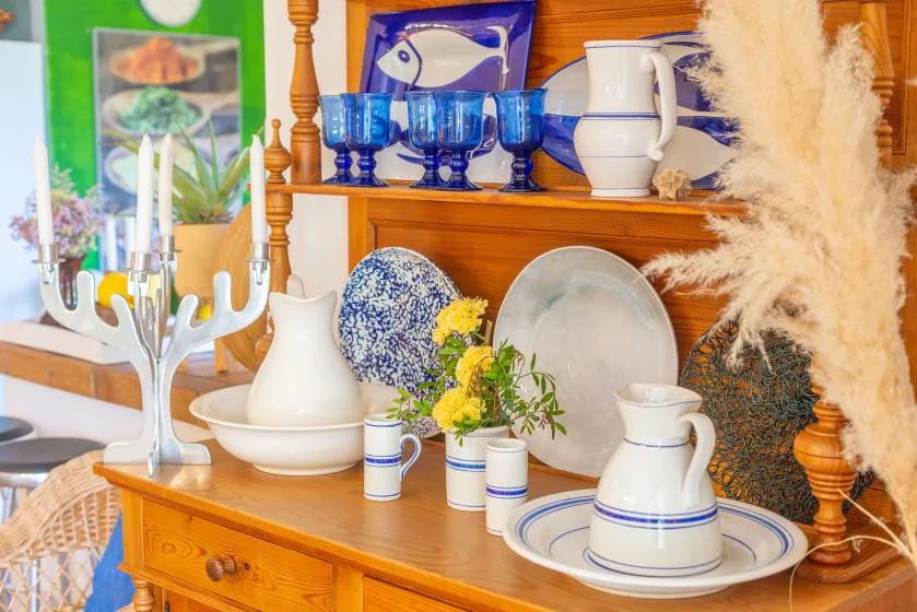 A dining-room display features blue-and-white ceramics on a wooden sideboard.