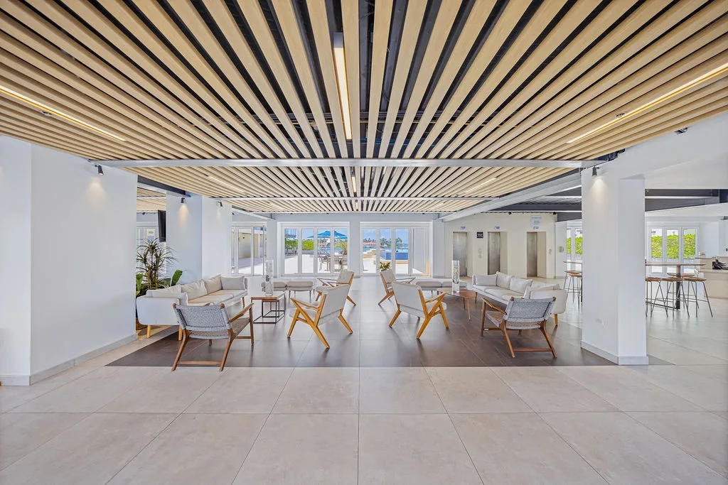 This spacious lobby welcomes you with modern Scandinavian-inspired design, warm wood accents, and comfortable seating