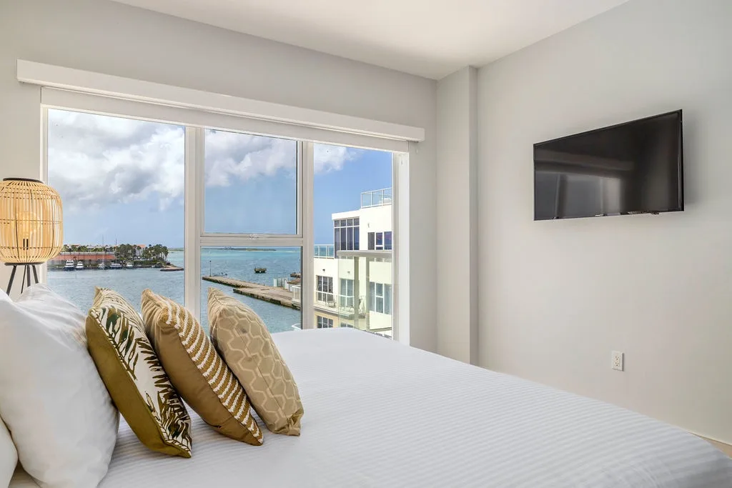 Your bedroom offers a peaceful retreat with modern comfort, calming neutral tones, and a large TV for relaxing.