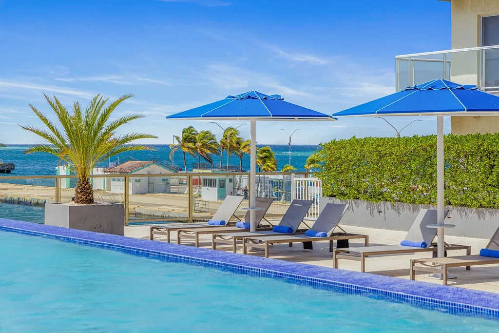 Sparkling pool meets blue sky and ocean horizon