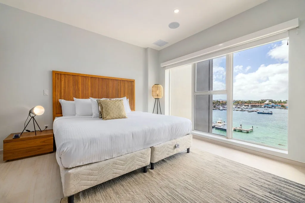Wake up to stunning waterfront views of the marina from your comfortable bed.