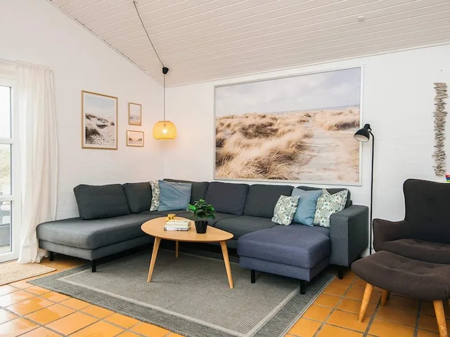 A living room with a sectional seating area and a coffee table.