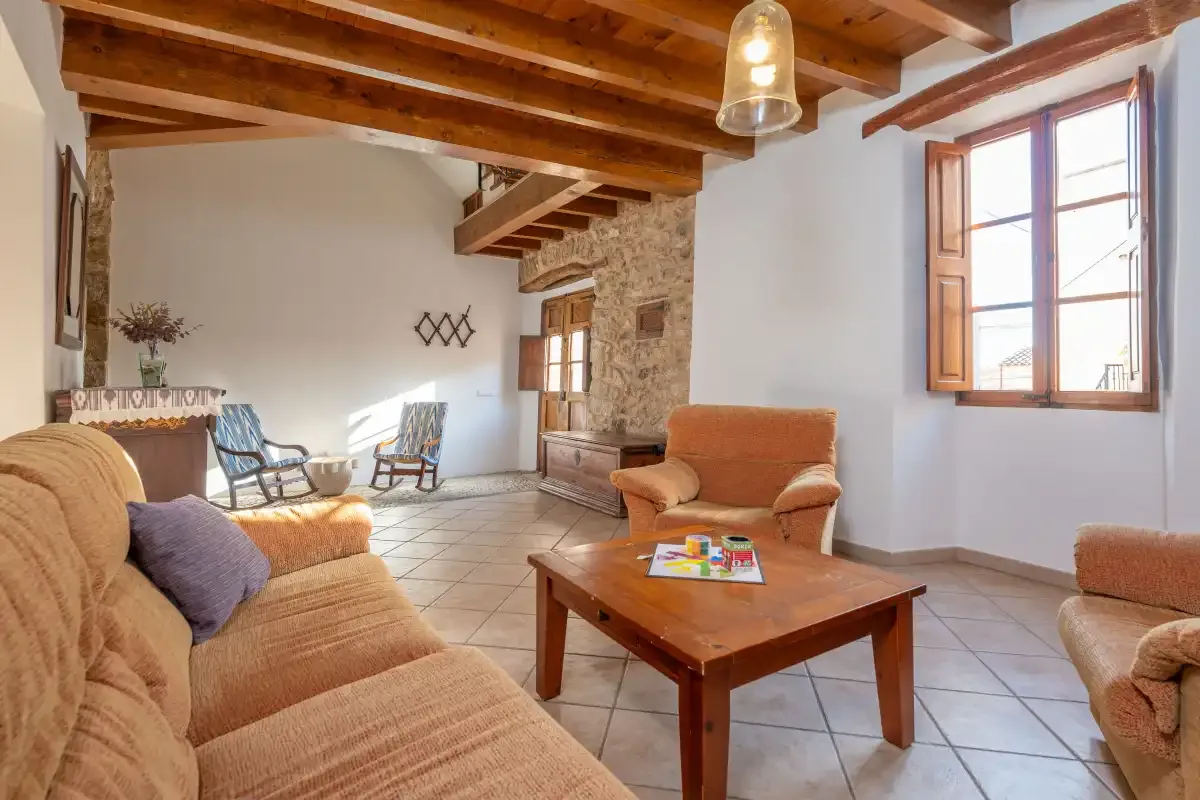 A living room with seating around a wooden coffee table.