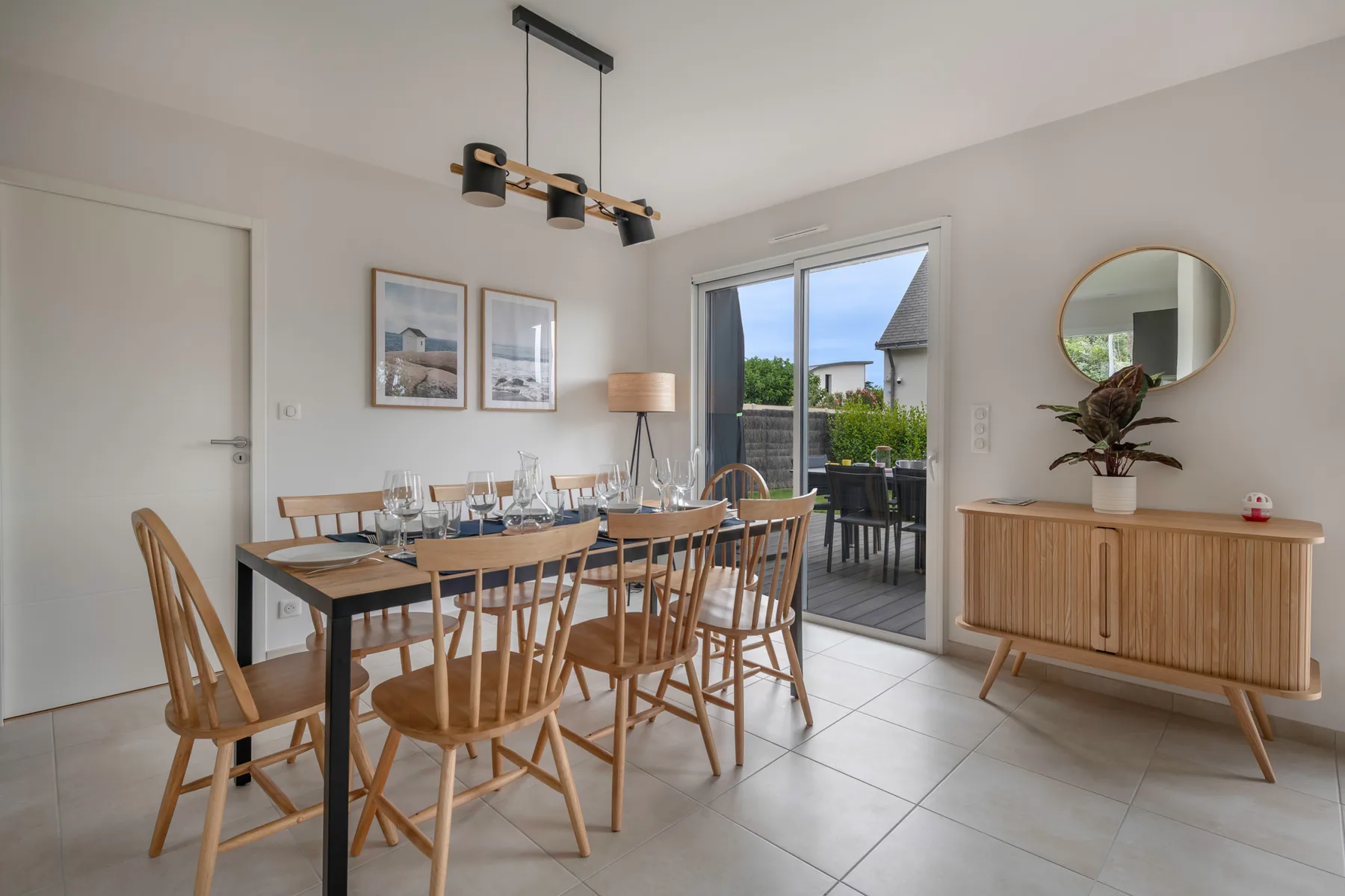 A bright dining area with a set table beside large glass doors.