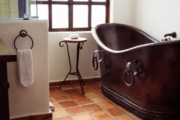 Baño del hotel con una tina de cobre.