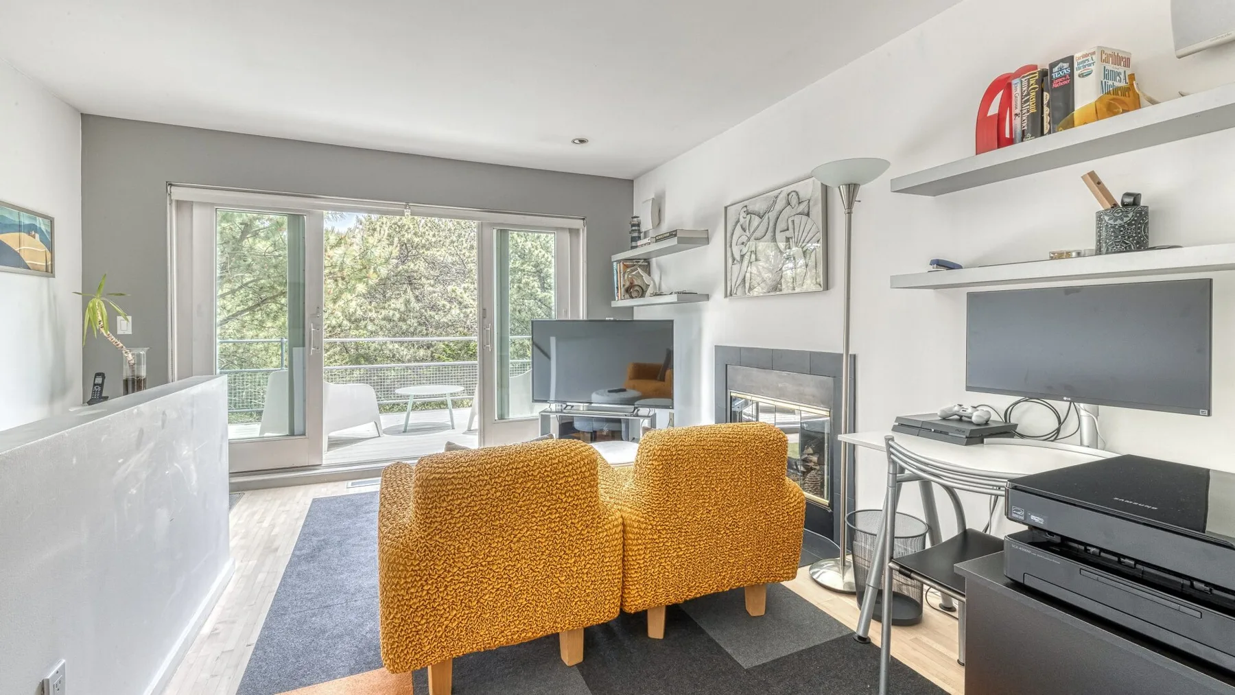A bright living room with seating, a television, and large glass doors.