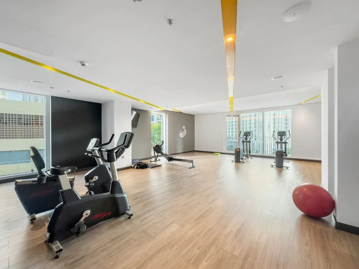 A bright fitness room with exercise bikes and other workout equipment.