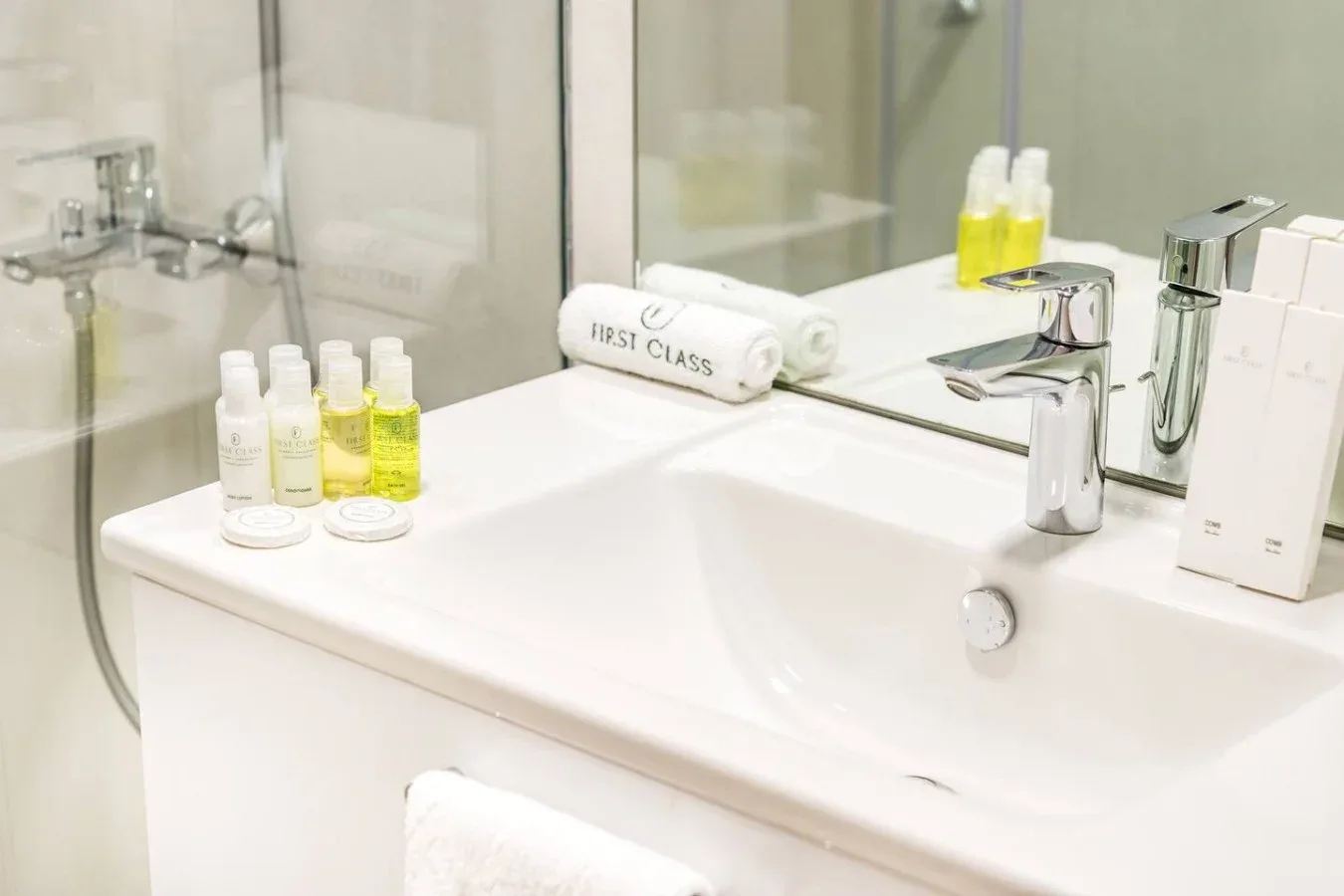 A bright bathroom vanity with a sink, toiletries, and a wall mirror.