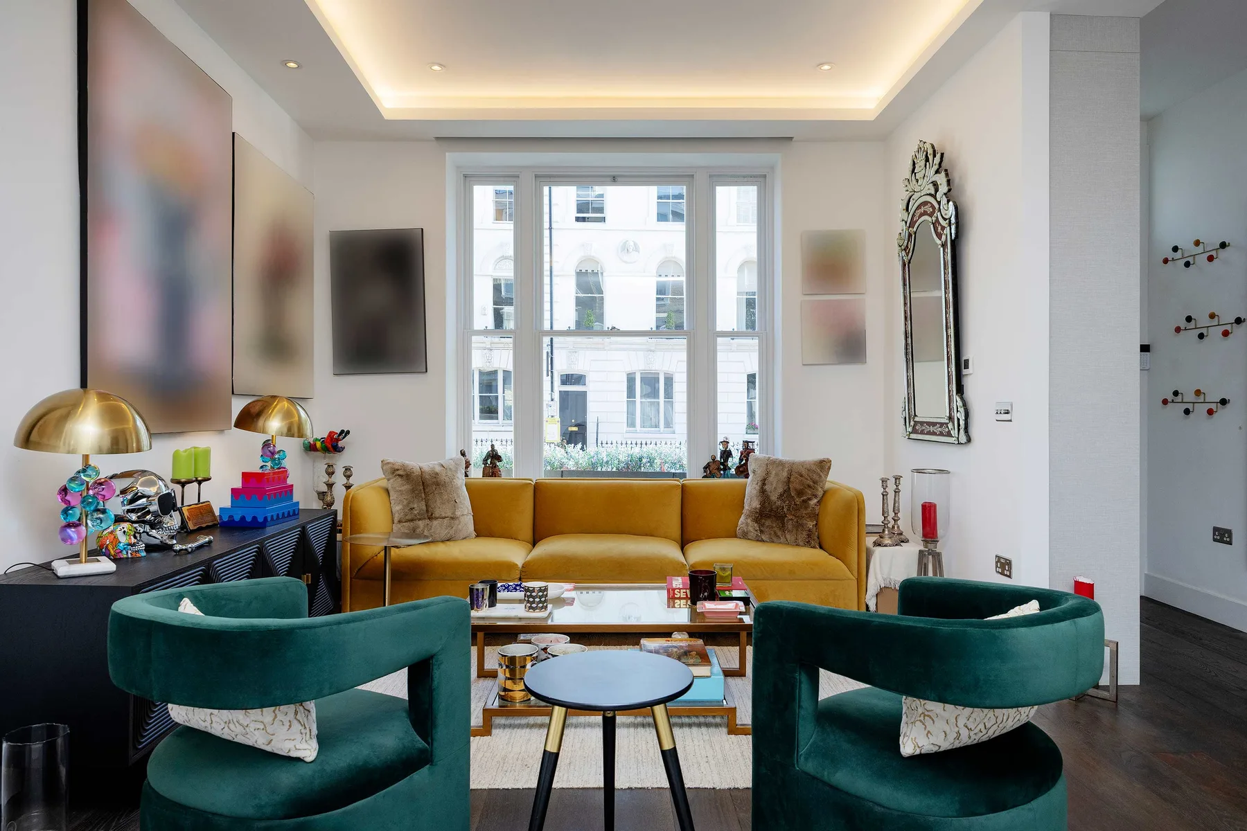 A bright living room with seating arranged around a low coffee table.