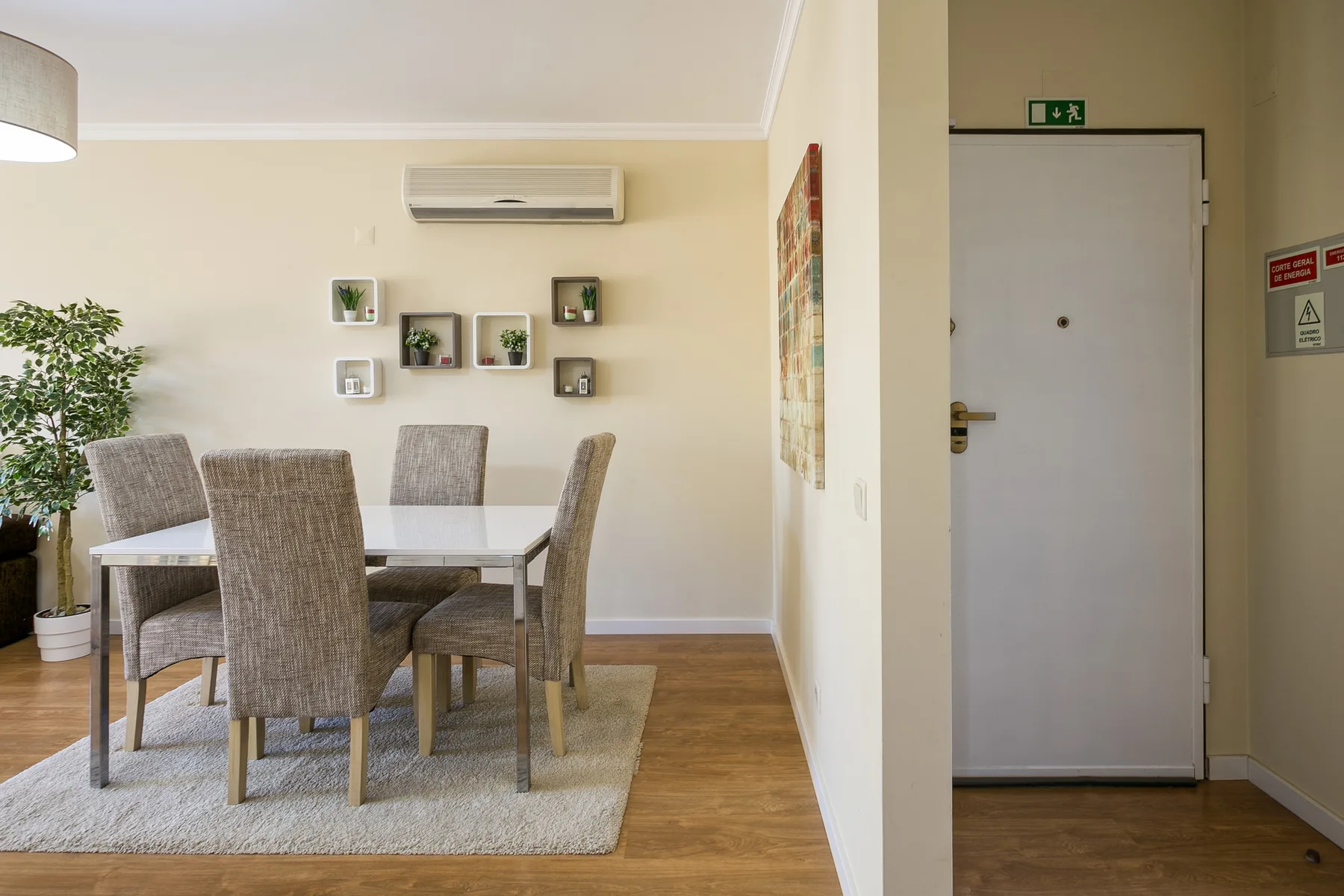 A dining area with a table and seating beside a hallway.