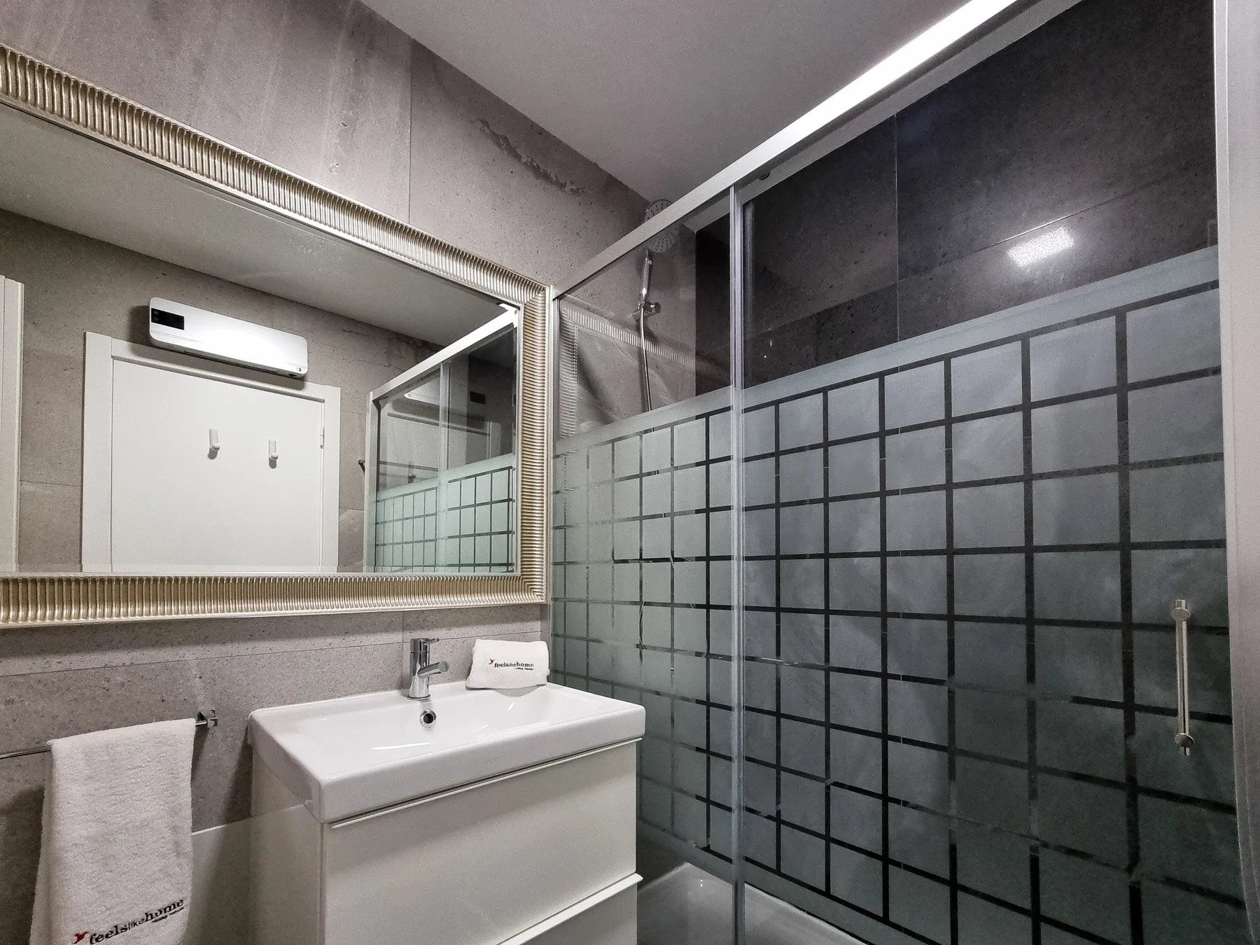 A bathroom with a sink and a glass shower.