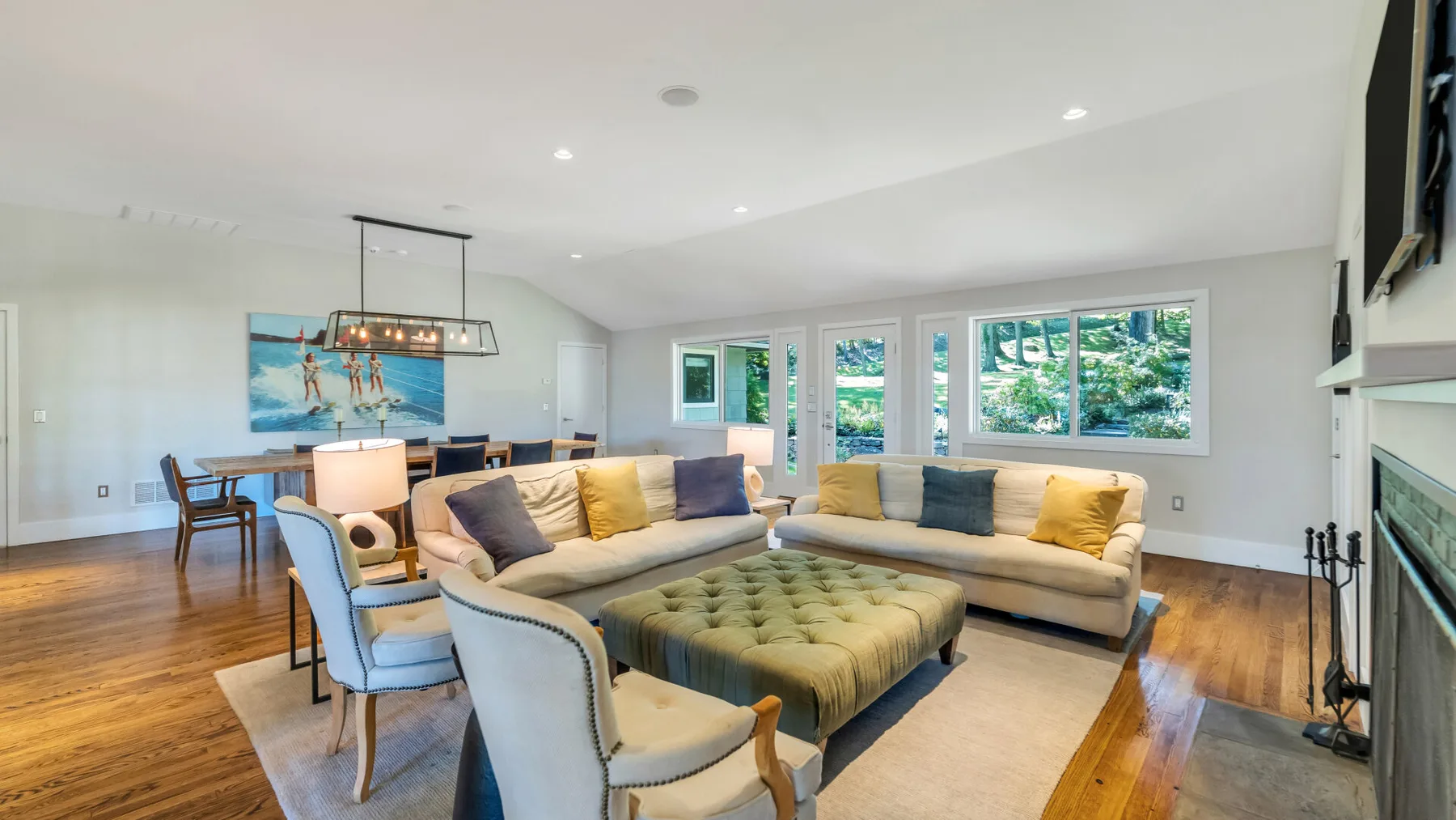 A bright living room with a sectional seating area and a large ottoman.