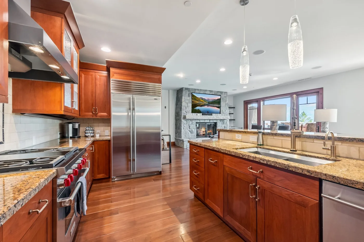A spacious kitchen with wooden cabinets, stainless steel appliances, and a large central island.