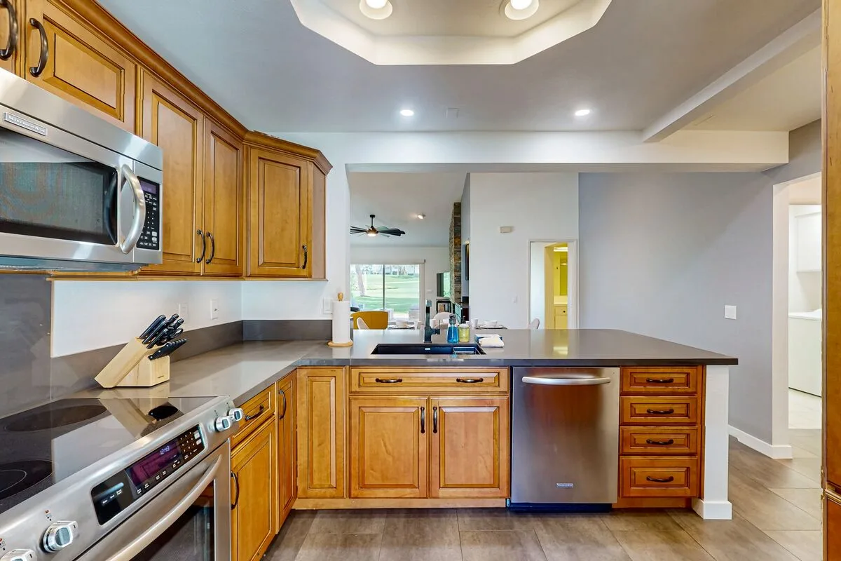 A kitchen with wooden cabinets and a central island.