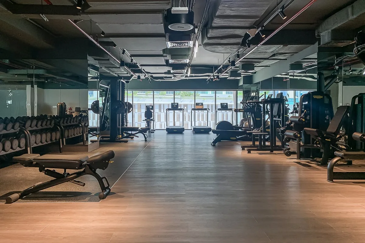 A gym with exercise equipment arranged around an open central floor.