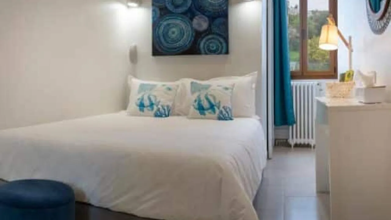 Modern room with a double bed and marine-themed decor.