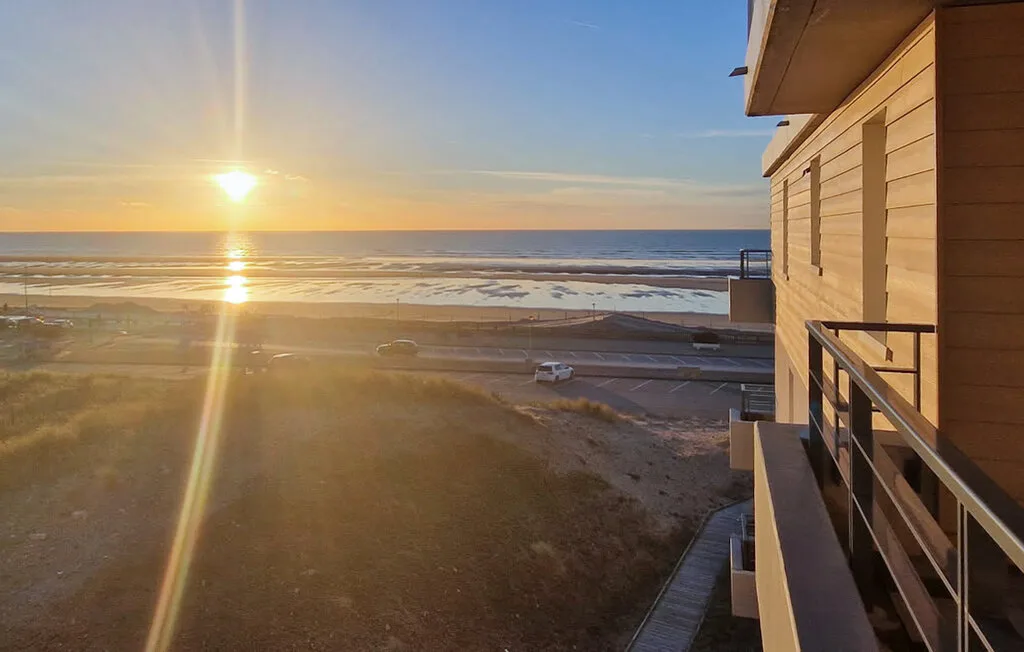 Sunset over the ocean, viewed from a balcony.