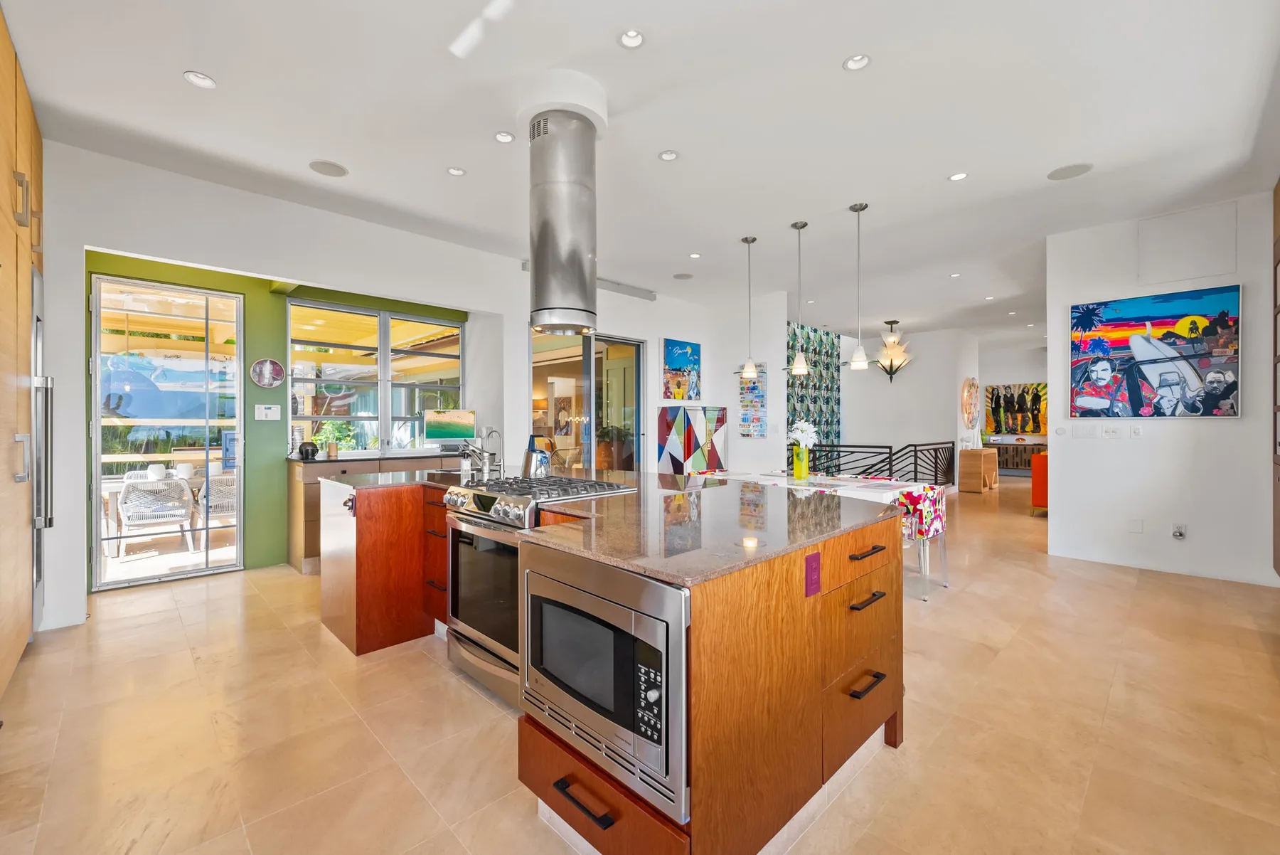 A modern kitchen with a central island and stainless-steel appliances.