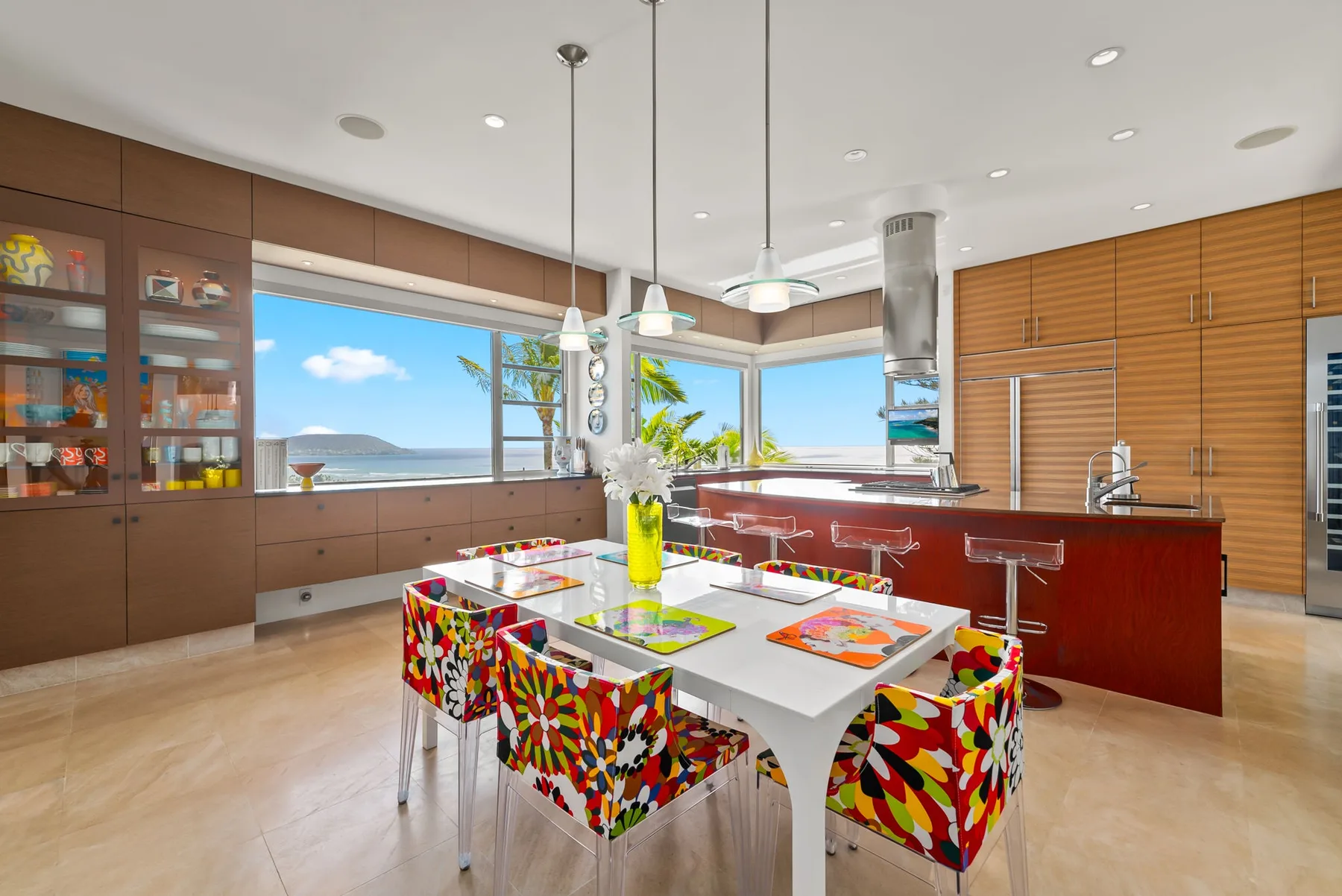 A bright kitchen and dining area with colorful seating around a table.