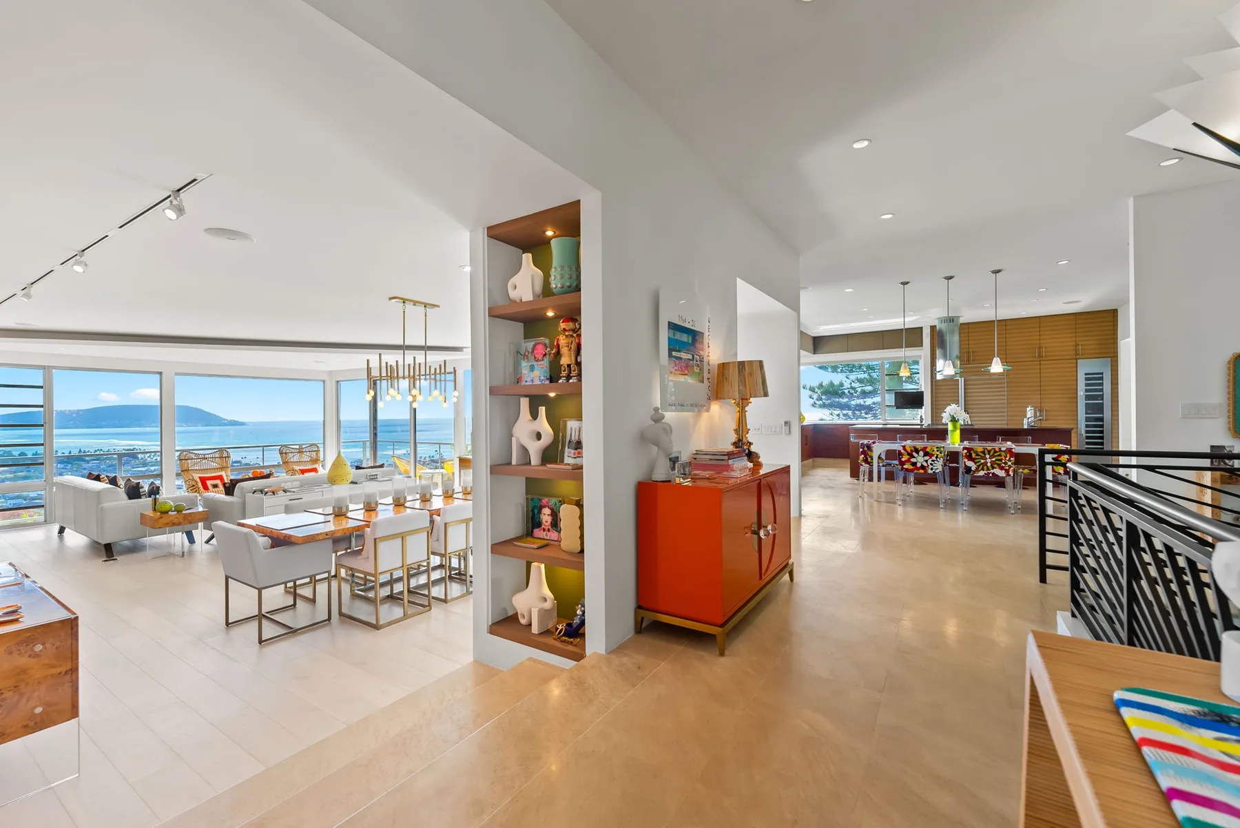 Open-plan living and dining area with large windows overlooking the water.