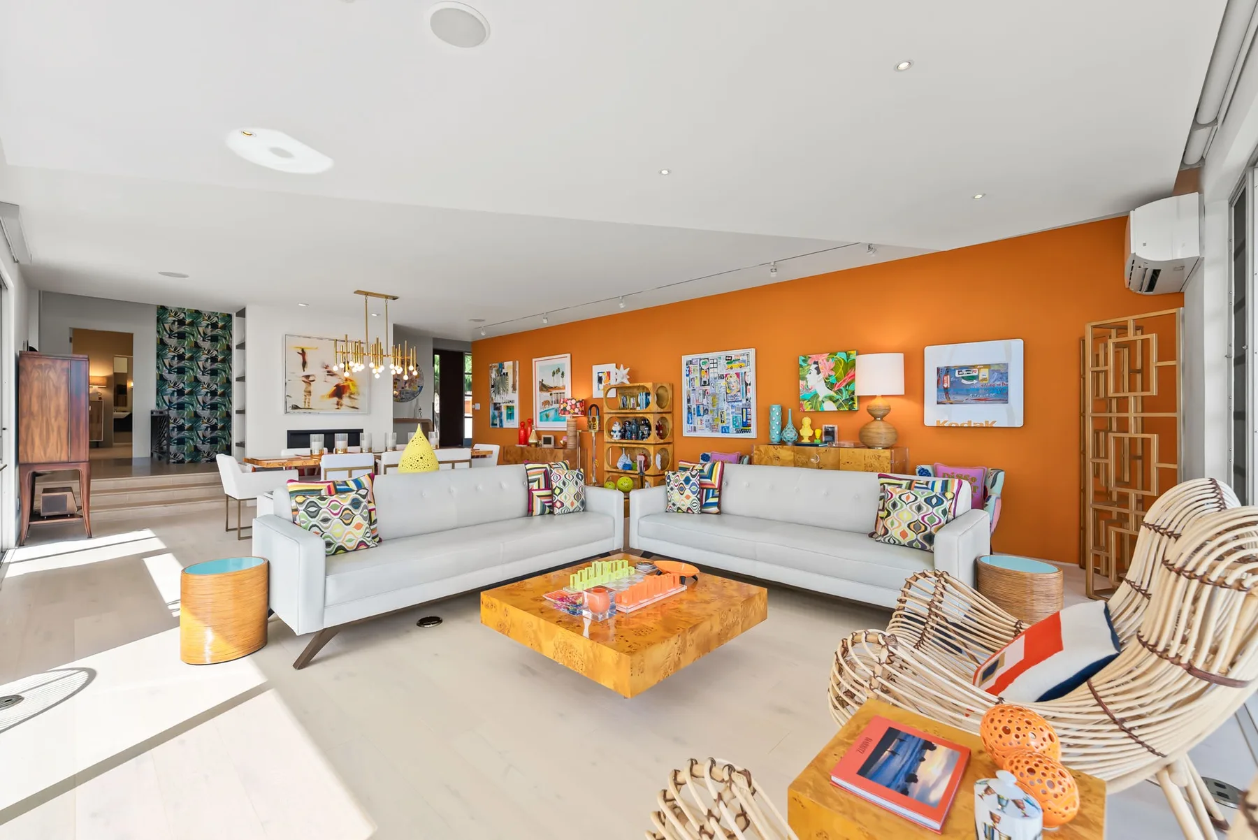 A bright living room with seating arranged around a low wooden coffee table.