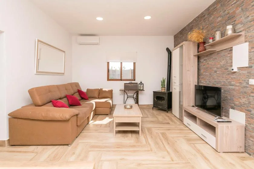 A living room with seating, a coffee table, and a television.
