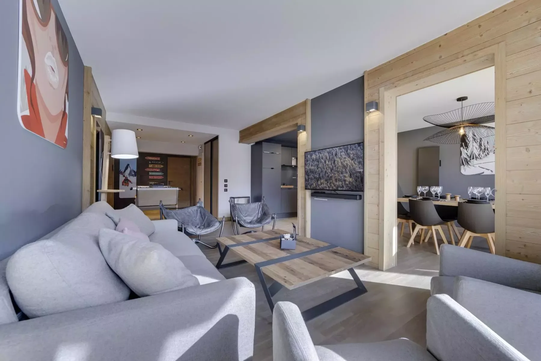 A modern living room with light seating and a wooden coffee table.