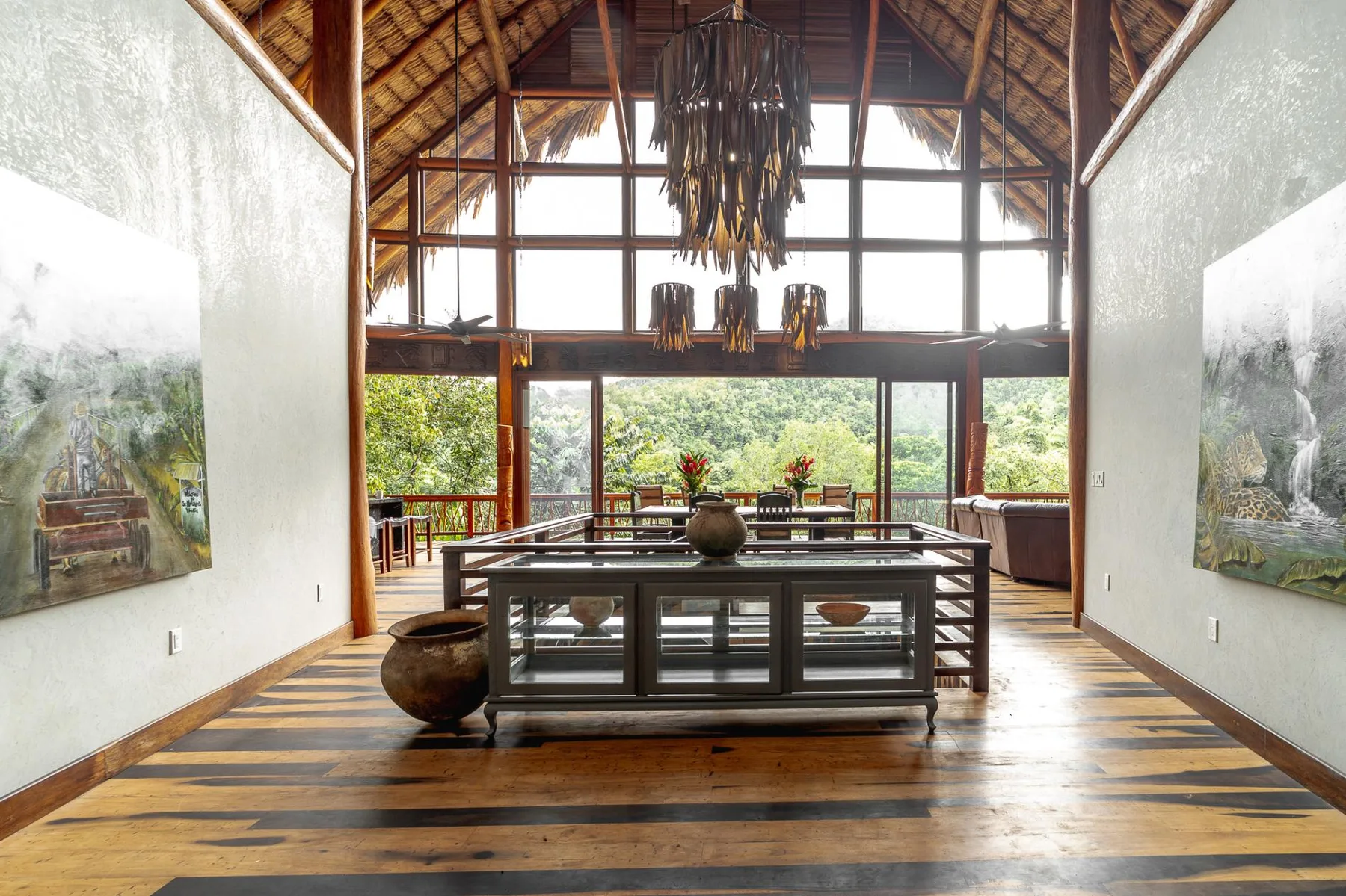 A spacious interior with a high timber roof, large windows, and a central display table.