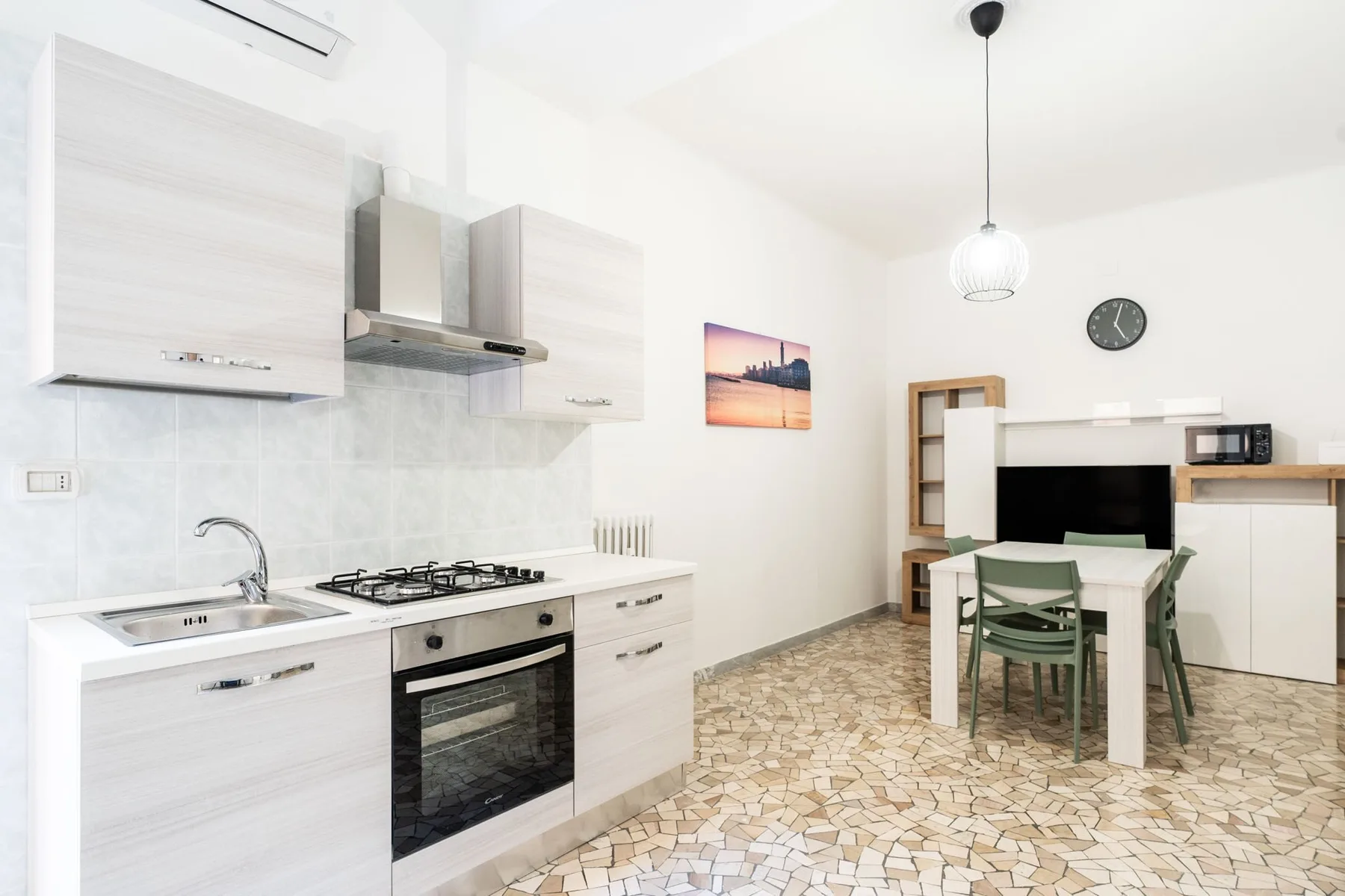 A bright kitchen and dining area with light cabinetry and a table.