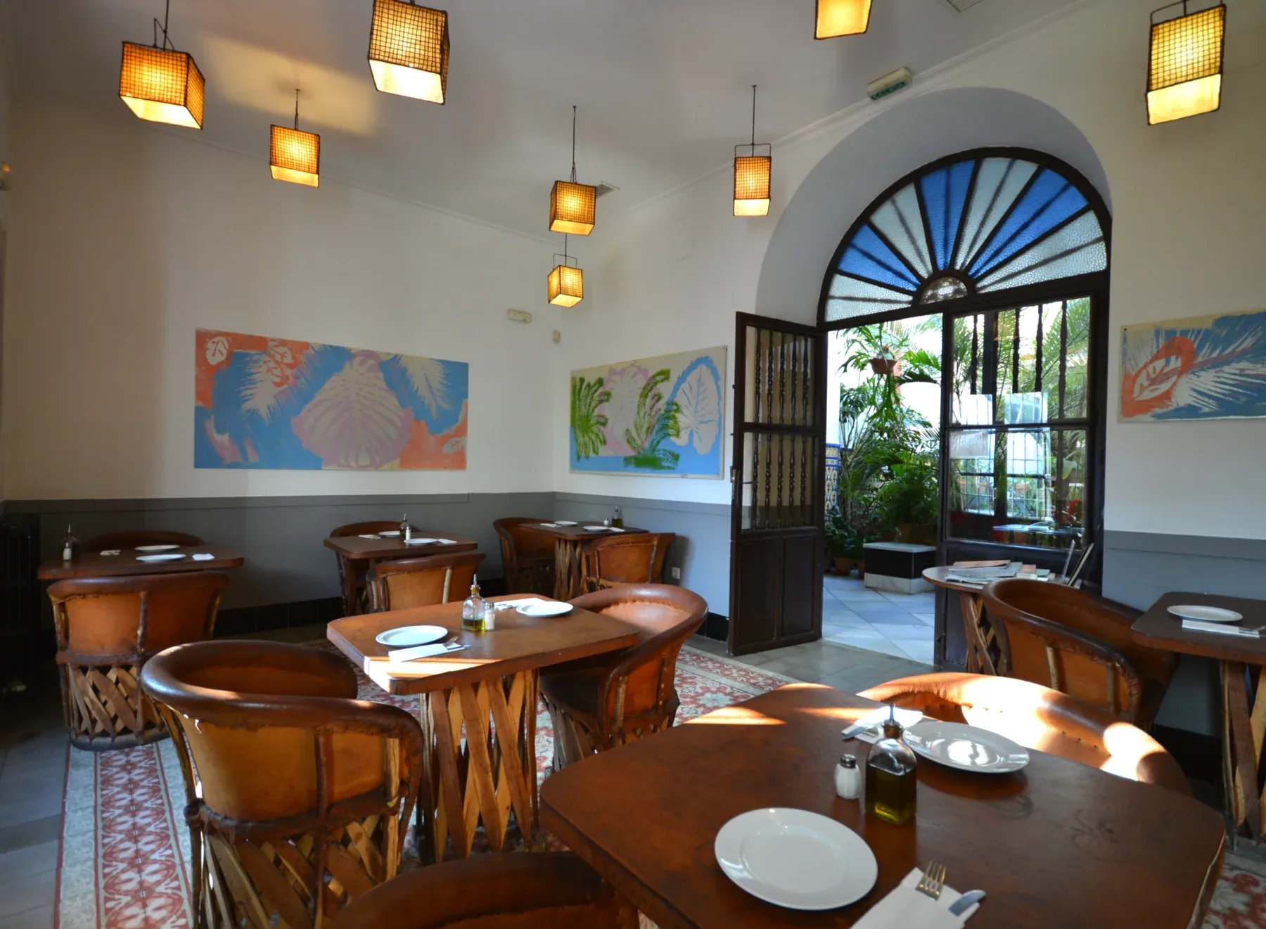 Breakfast room with tables and windows overlooking the patio
