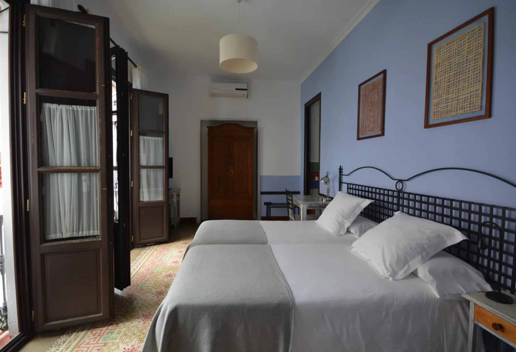 Ceiba room with two beds and balconies overlooking the main patio