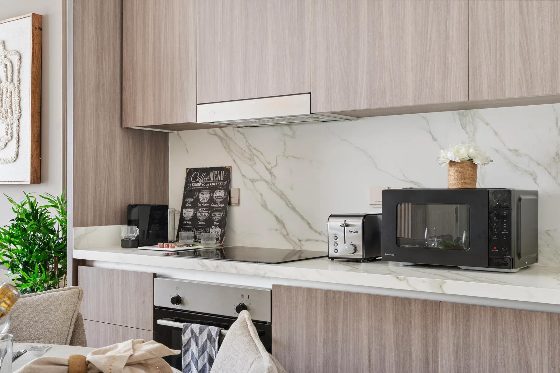 A modern kitchen with wood cabinets, a countertop, and appliances.