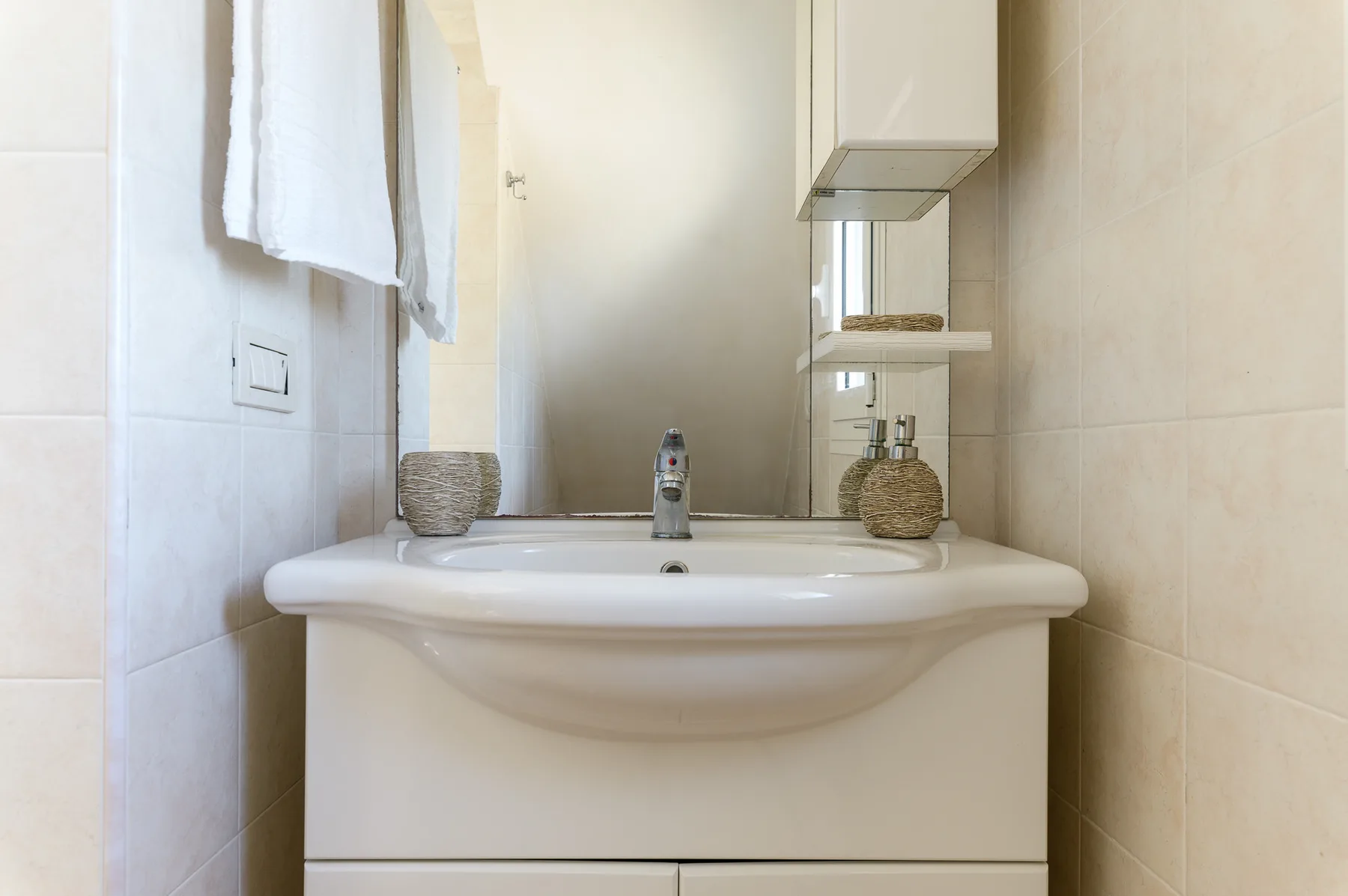 A bathroom vanity with a sink and mirror.
