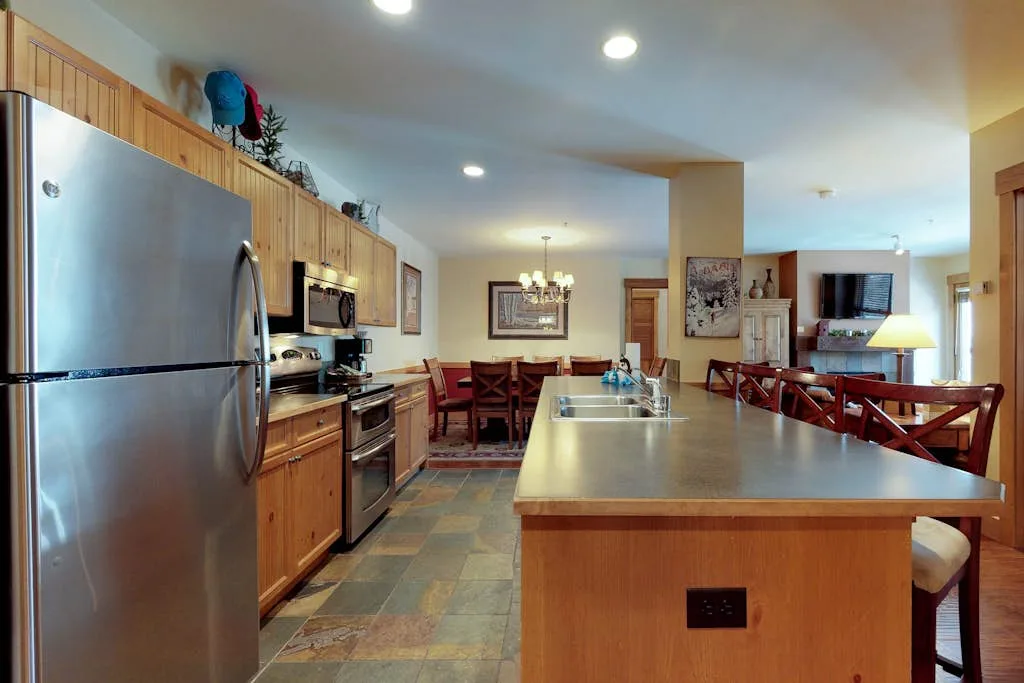 A kitchen with a large island and dining table.