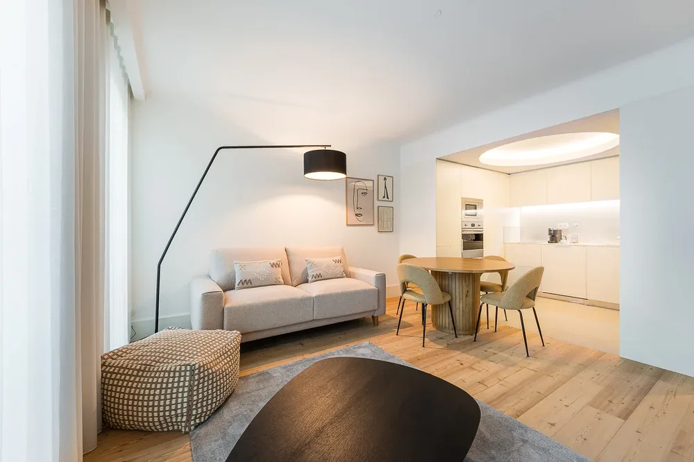 A bright living room opens onto a dining area and kitchen.