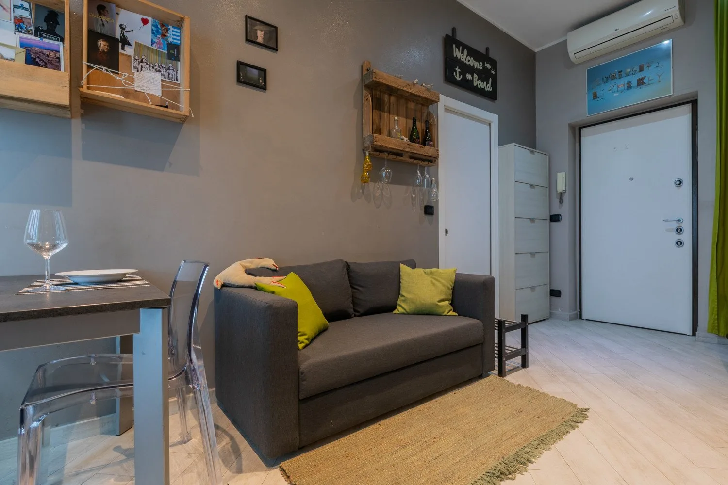 Living room with a sofa and dining table beside the entrance.