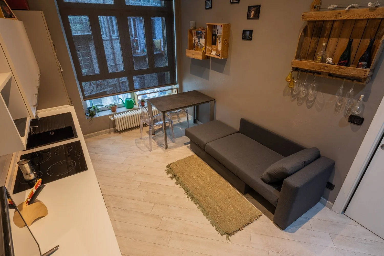 A compact kitchen and seating area with a table beside the window.