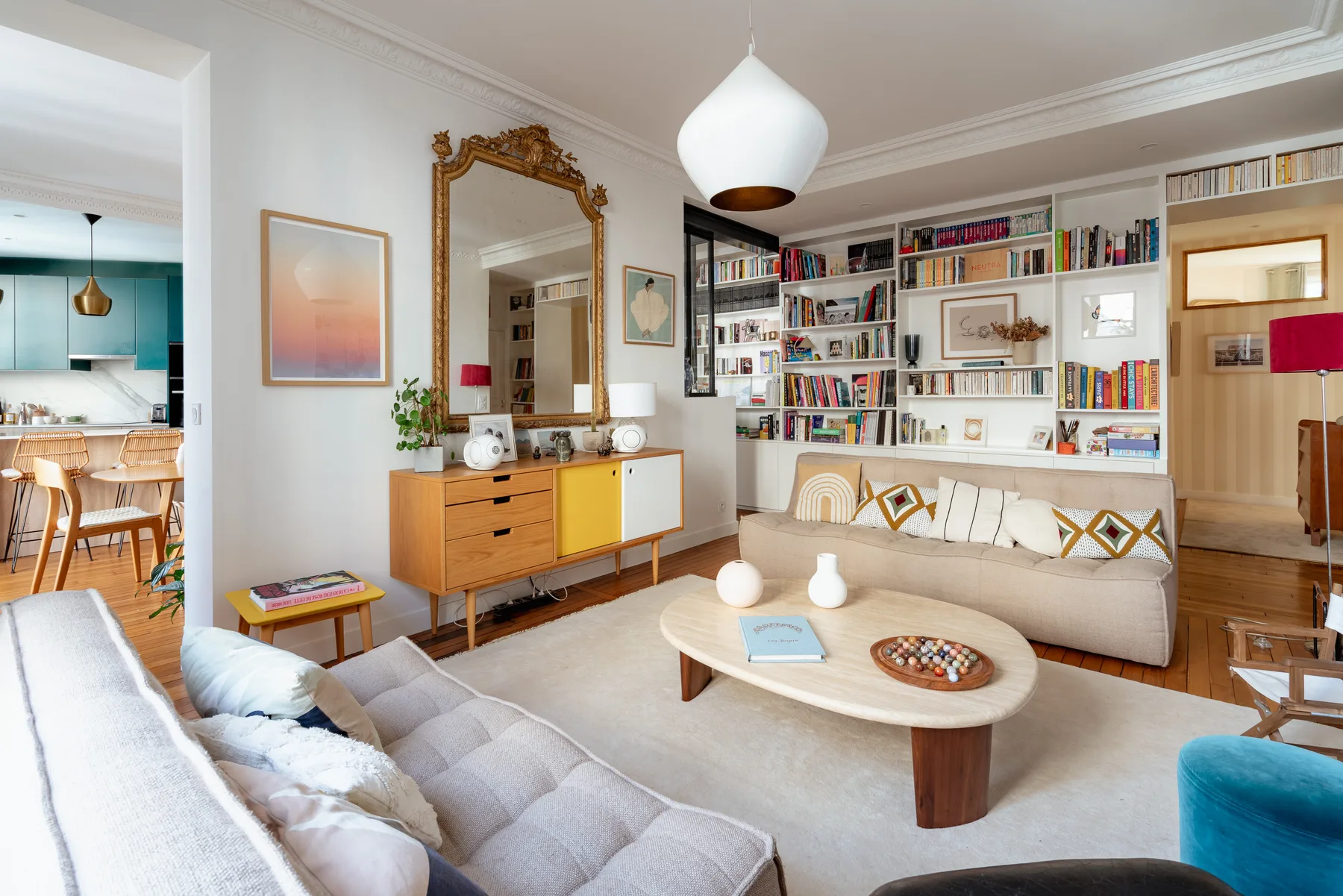 A bright living room with built-in bookshelves and a seating area around a coffee table.