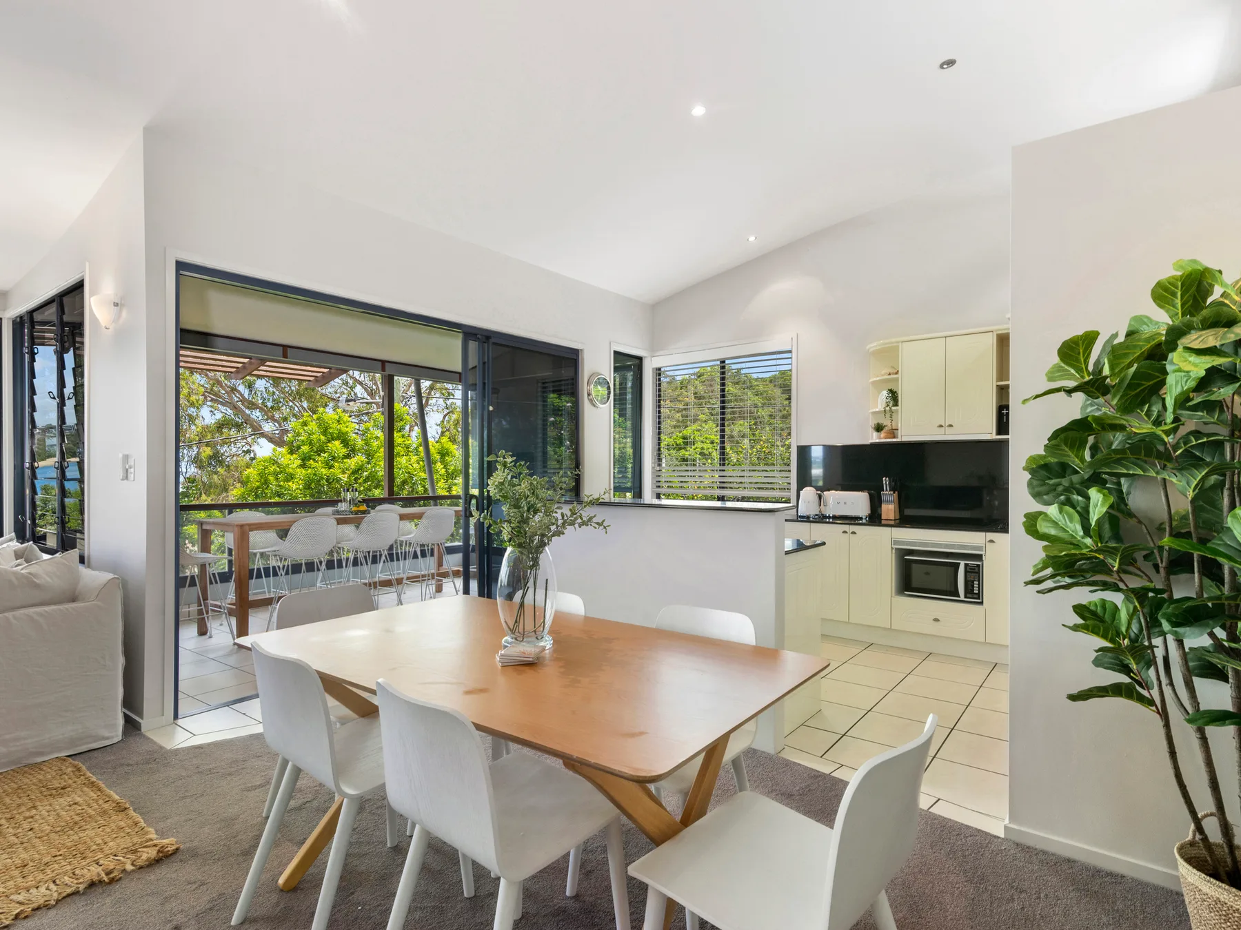 A bright dining area opens onto a balcony beside the kitchen.