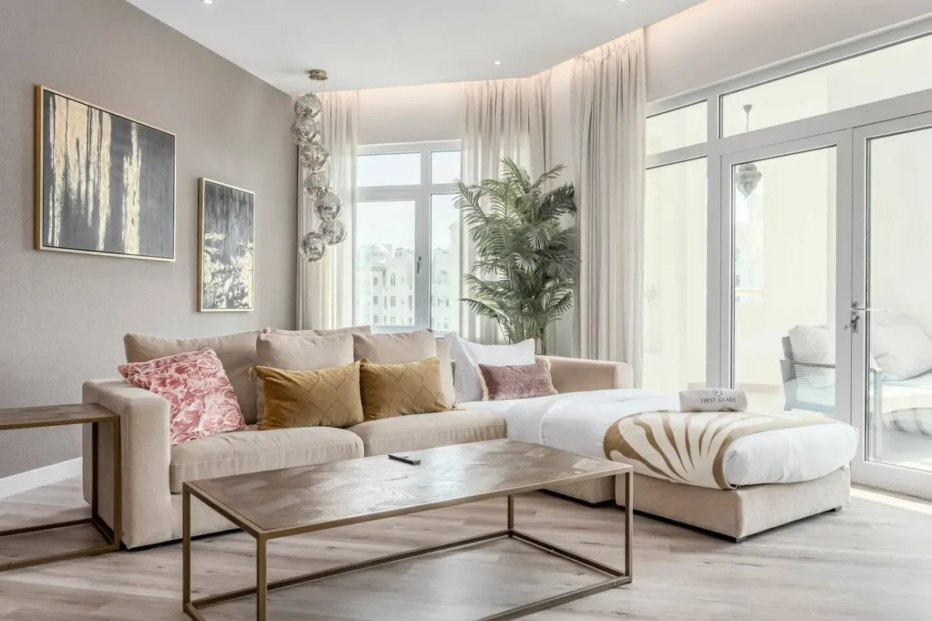 A bright living room with a sectional seating area beside large windows.